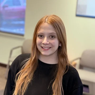 Mia smiling in a black shirt.